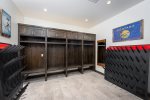 The ski locker room features built-in custom cabinetry, boot & glove warmers and heated flooring.